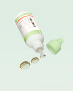 A'PIEU The Pure Tea Tree Essence open bottle with essence droplets