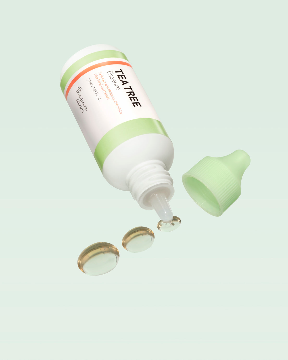 A'PIEU The Pure Tea Tree Essence open bottle with essence droplets
