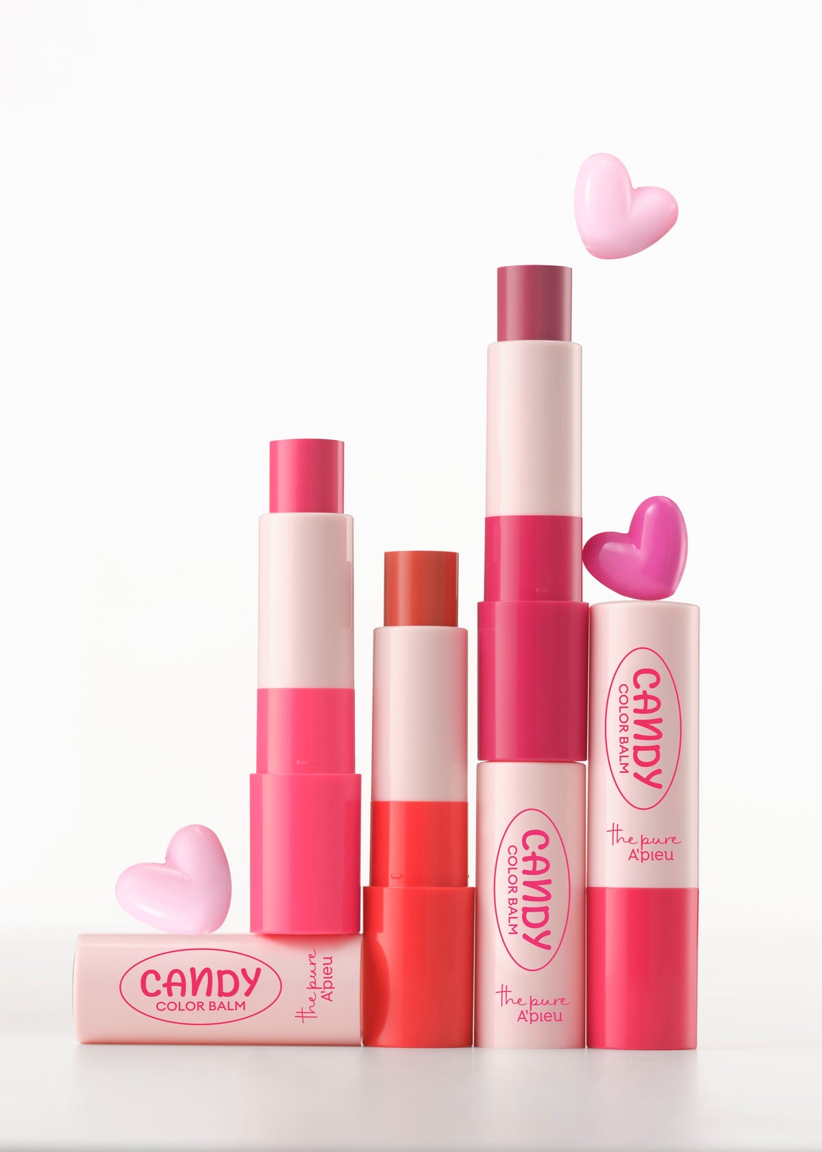 A'PIEU Candy Color Balm trio displayed open with heart-shaped props